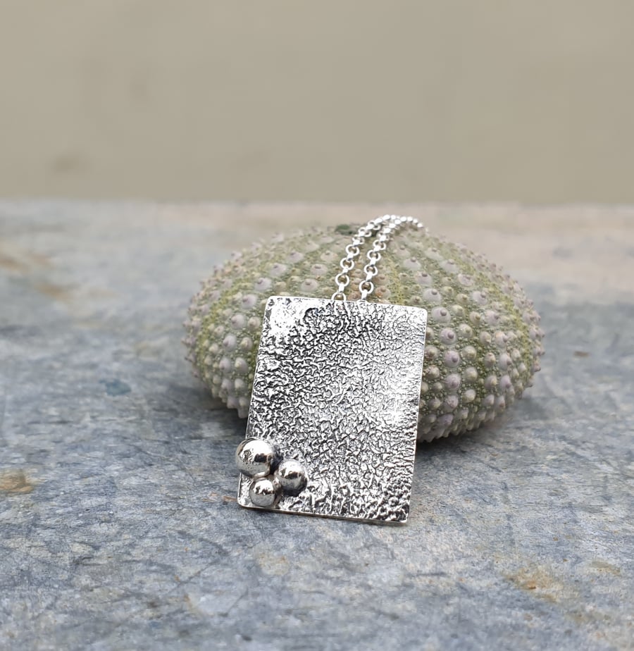 Rectangular textured silver pendant