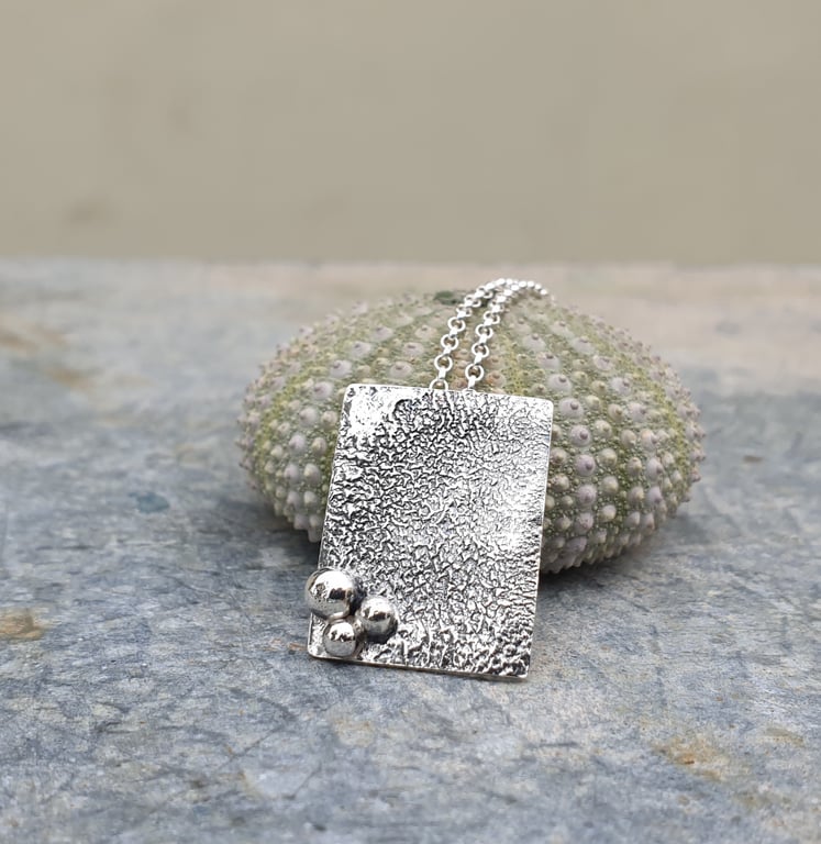 Rectangular textured silver pendant