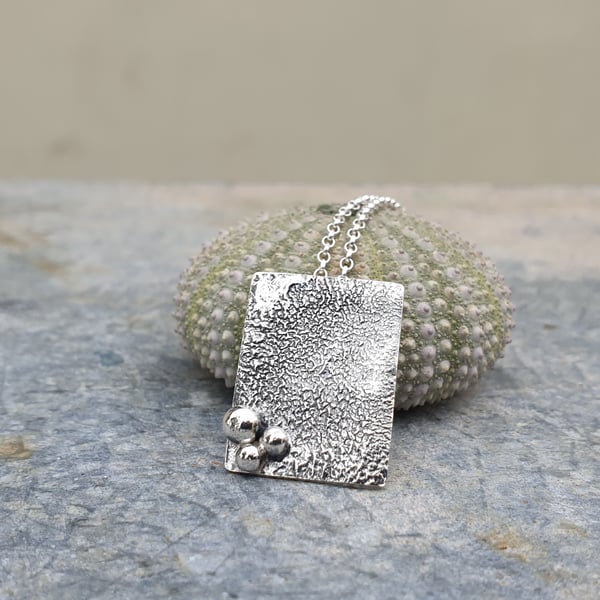 Rectangular textured silver pendant