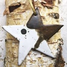 Handmade stoneware dancing star decoration in neutral toned glazes