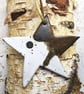 Handmade stoneware dancing star decoration in neutral toned glazes