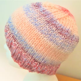 Hand knitted adult beanie hat in apricot and lilac colour changing yarn