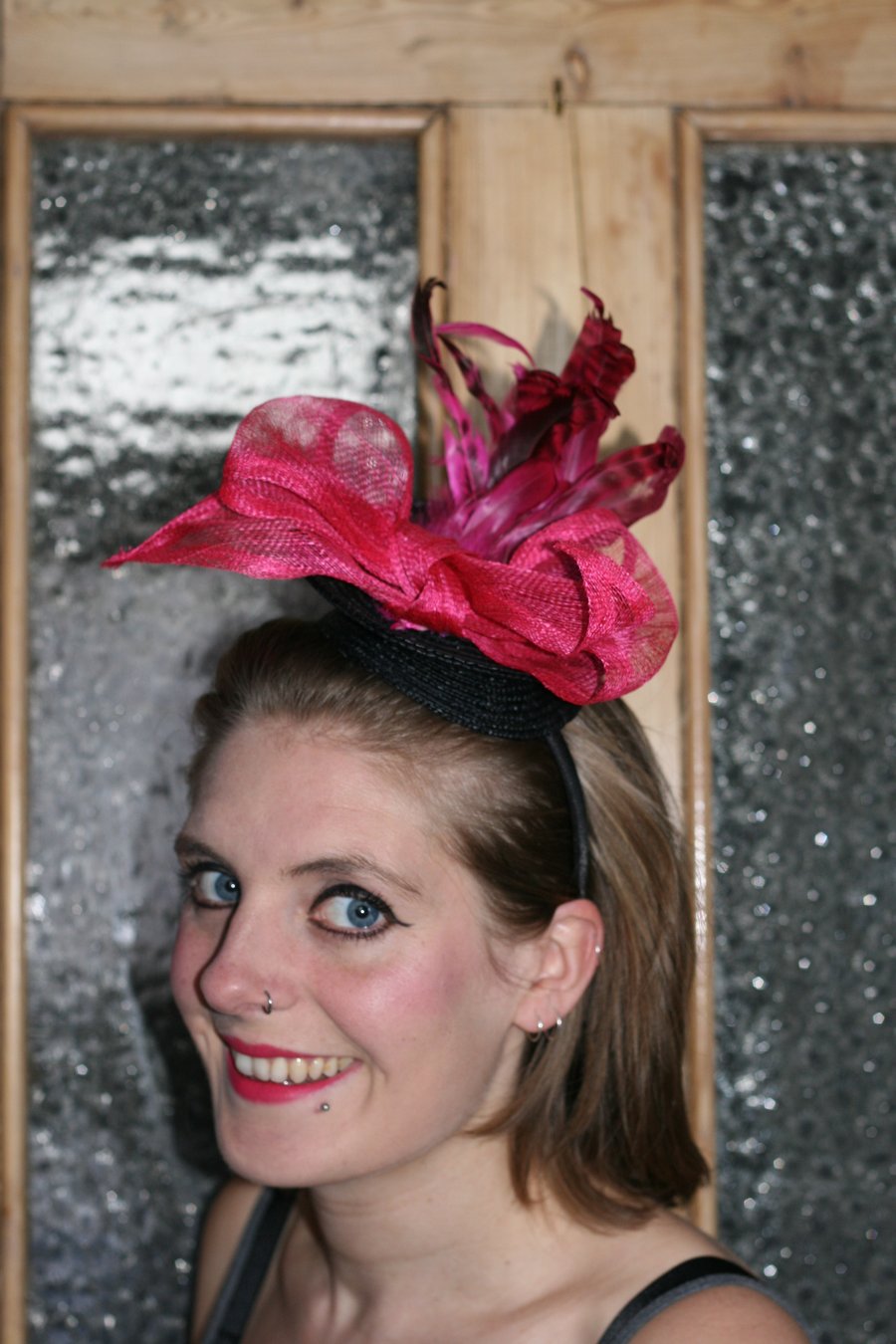 Black fascinator with hot pink bow and feathers