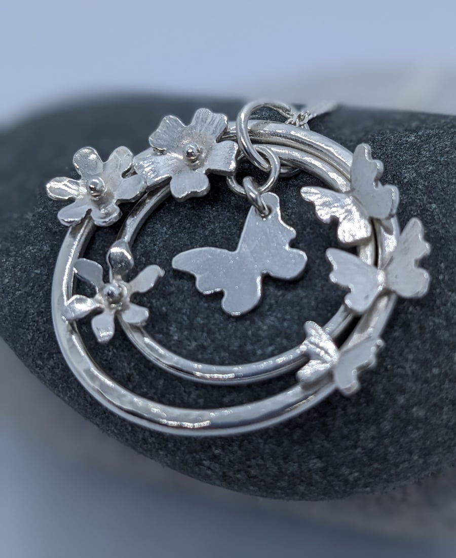 Handmade silver pendant with butterflies and flowers
