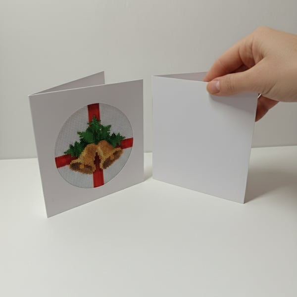 Hand-stitched Christmas card with embroidered festive bells and greenery