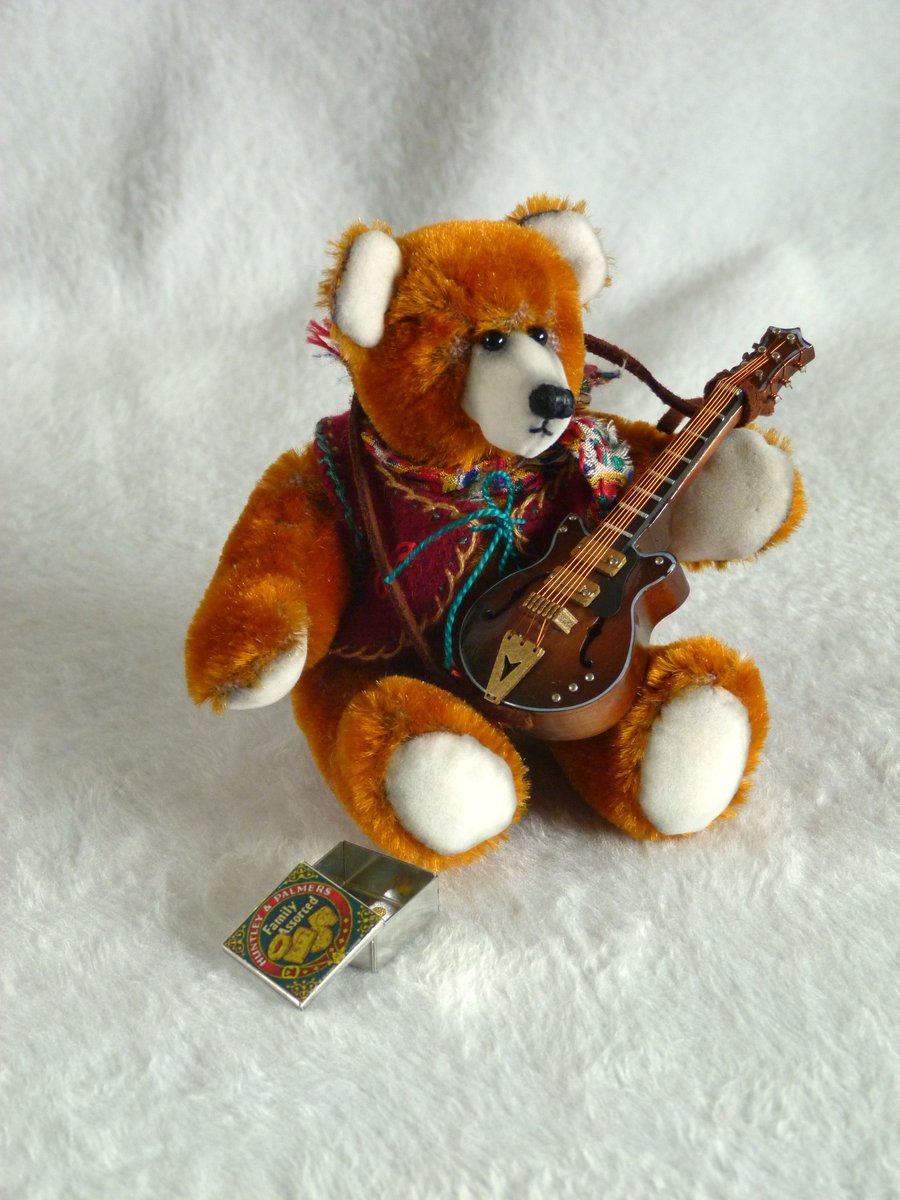 Django, a 5" collectable bear from antique velvet, plays guitar.