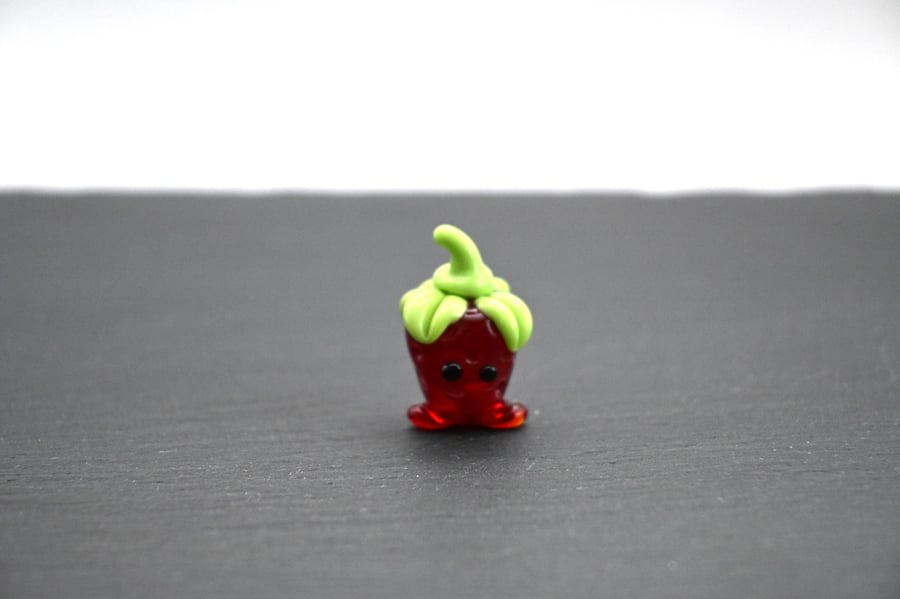 small glass strawberry figure