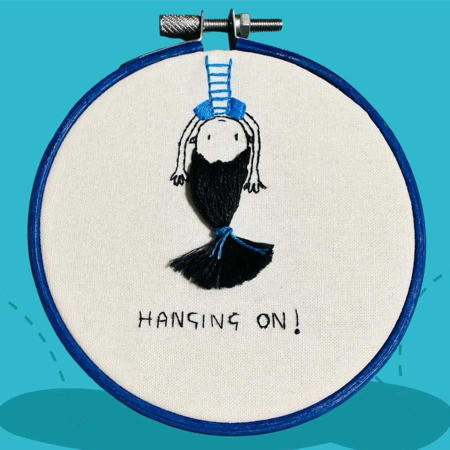 Funny motivational quote embroidery art of a girl “hanging on” upside down 