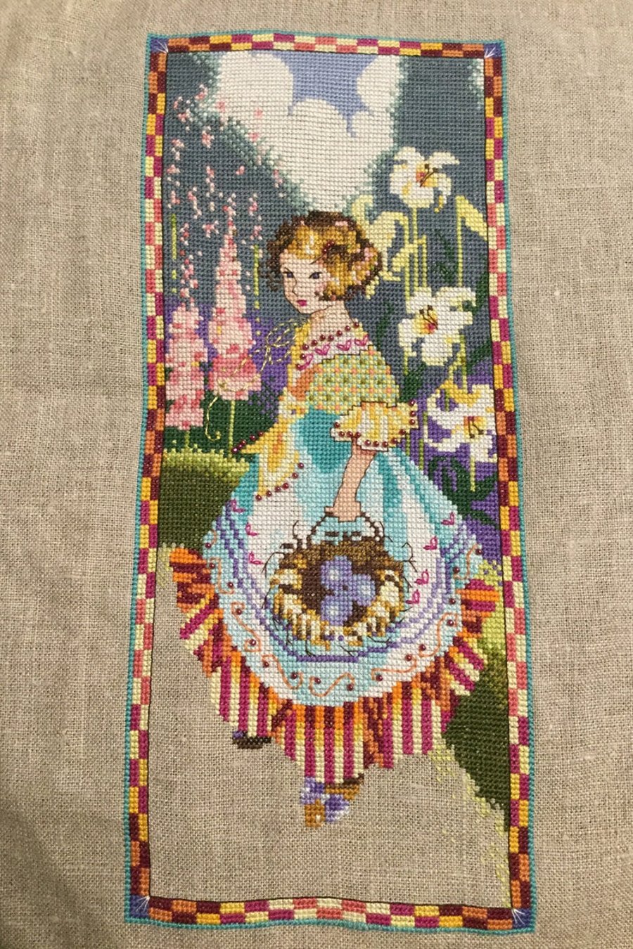Completed cross stitch unframed Mirabilia gathering eggs 5” x 12”