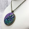 Geometric squares and dashes fabric button pendant in purples, blues and jades