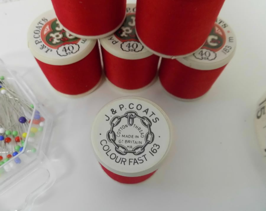 Six reels red cotton sewing thread