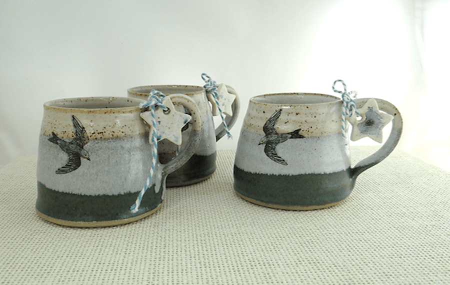 Ceramic mug with swallow image glazed in moss green - misty blue - creamy white