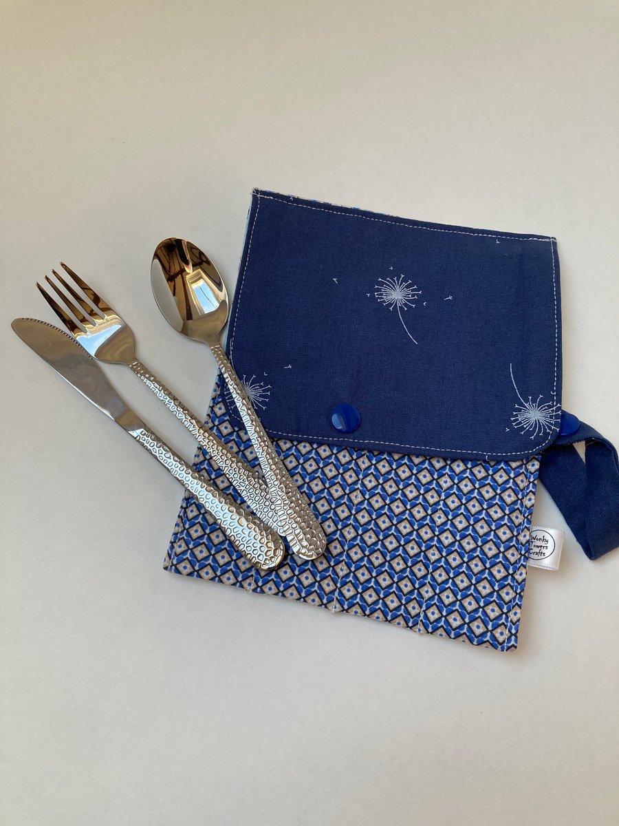 Travel cutlery roll with cutlery - mainly blues.