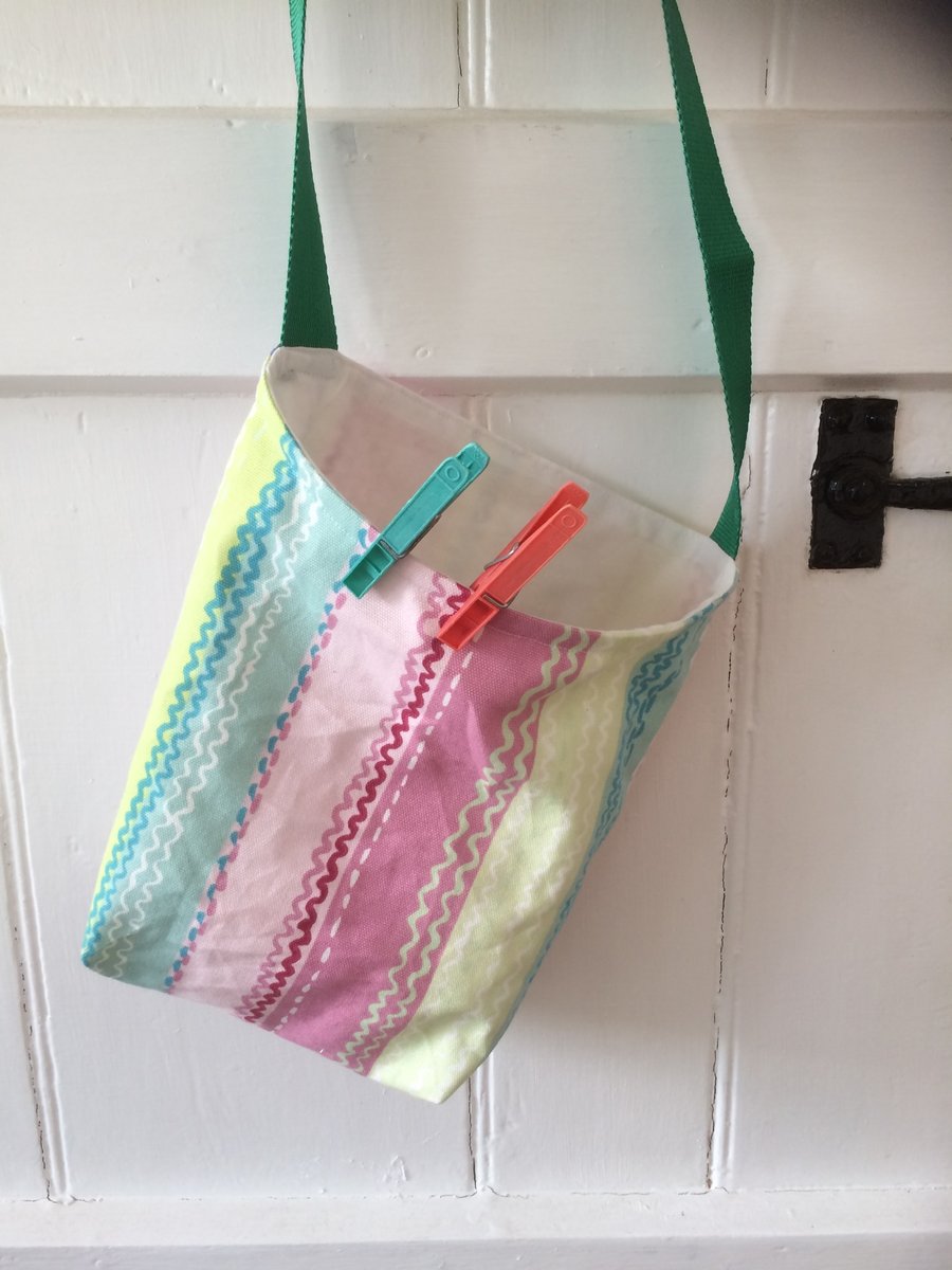 Peg bag with shoulder strap. Pastel stripes