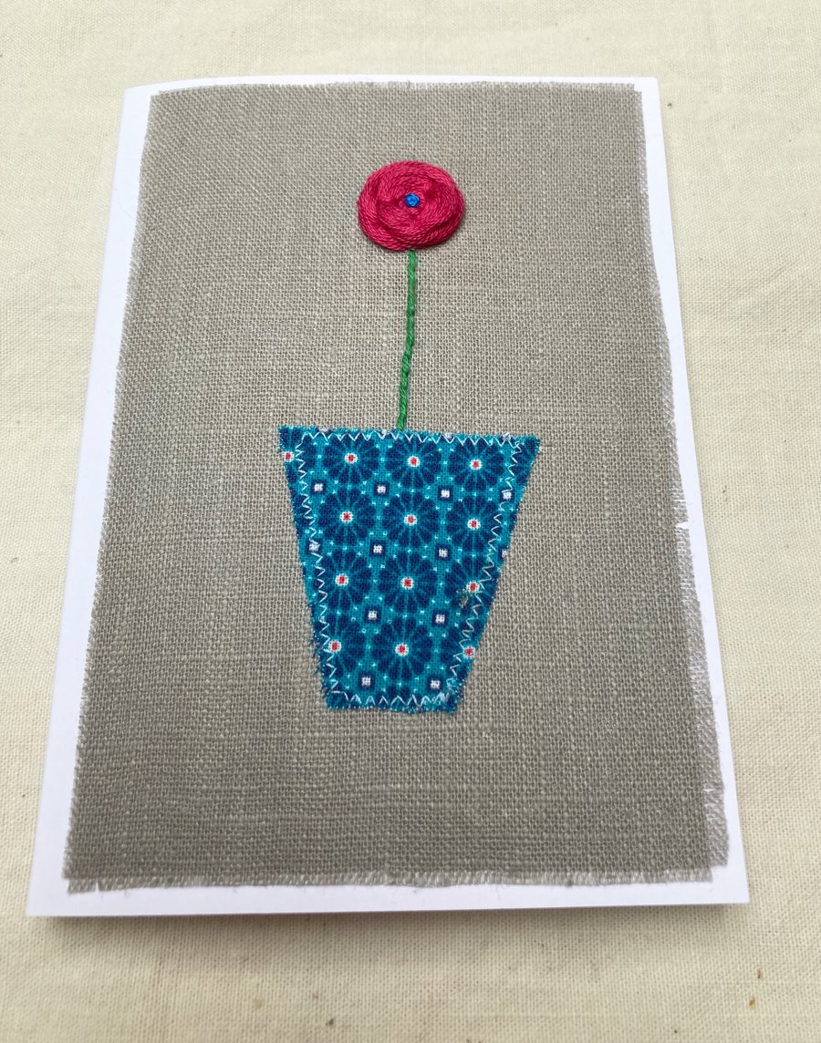 Coral pink flower embroidered card.