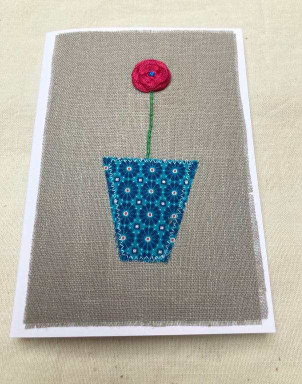 Coral pink flower embroidered card.