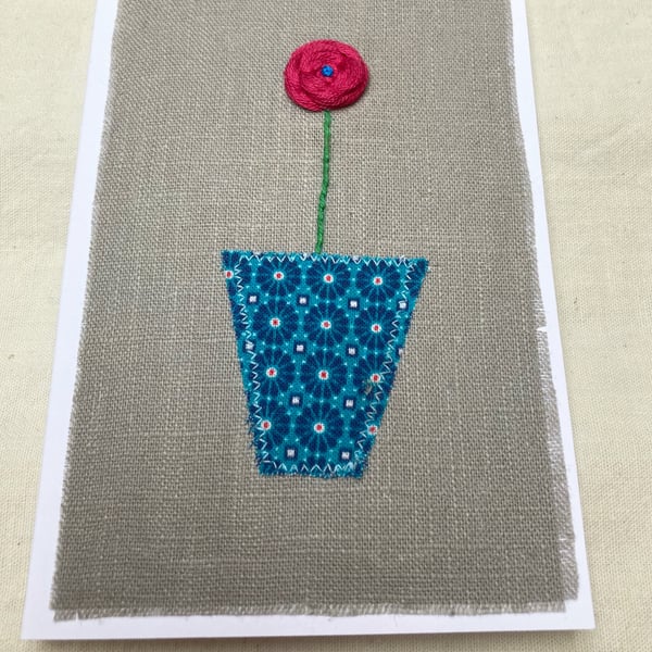 Coral pink flower embroidered card.