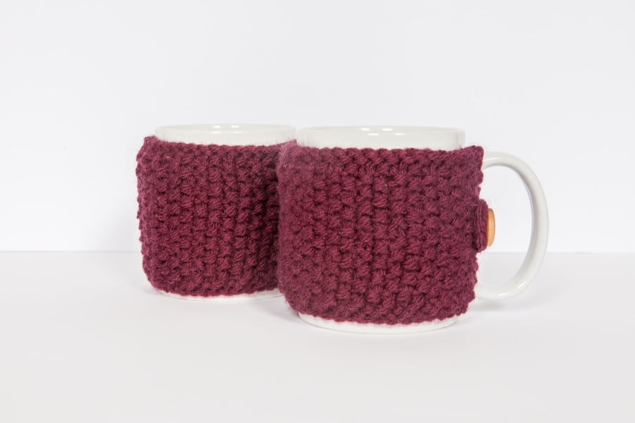 Pair of knitted mug cosies, cup cosy, coffee cosy in Plum. Coffee mug cosy