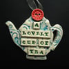 Ceramic teapot decoration with button flower