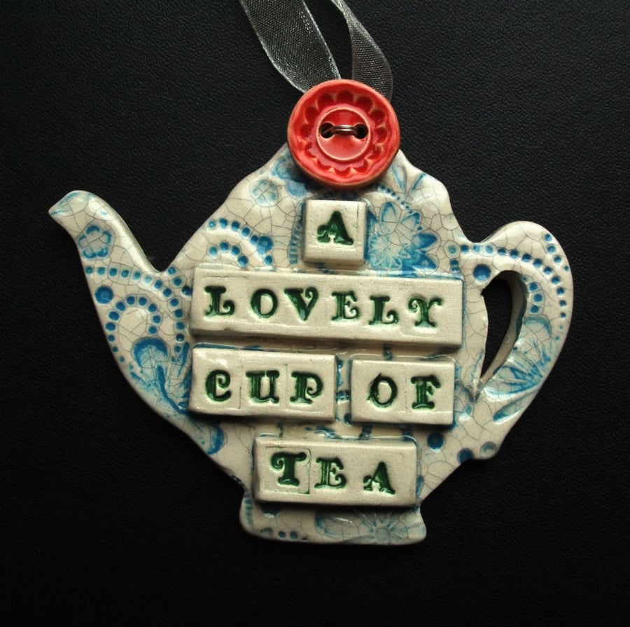 Ceramic teapot decoration with button flower
