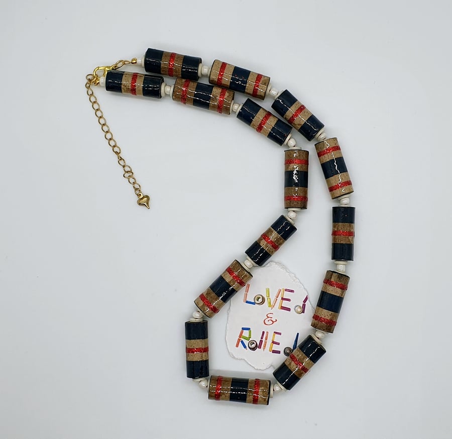 Necklace made of mottled brown paper with glittery red and blue stripes