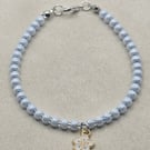 Pearl blue seed bead bracelet with small white flower charm