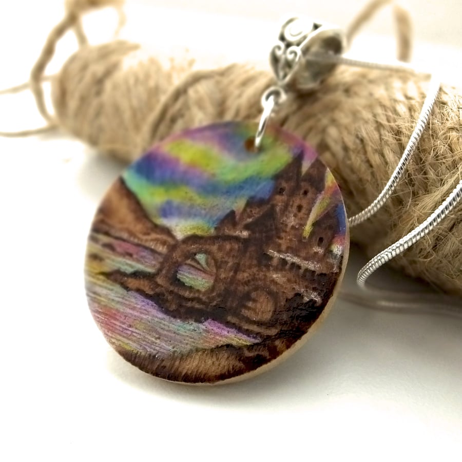Small Wooden Pyrography Disc Pendant with Seaside Castle and Aurora Borealis