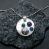 Circular silver pendant with turquoise, blue onyz and lapis lazuli