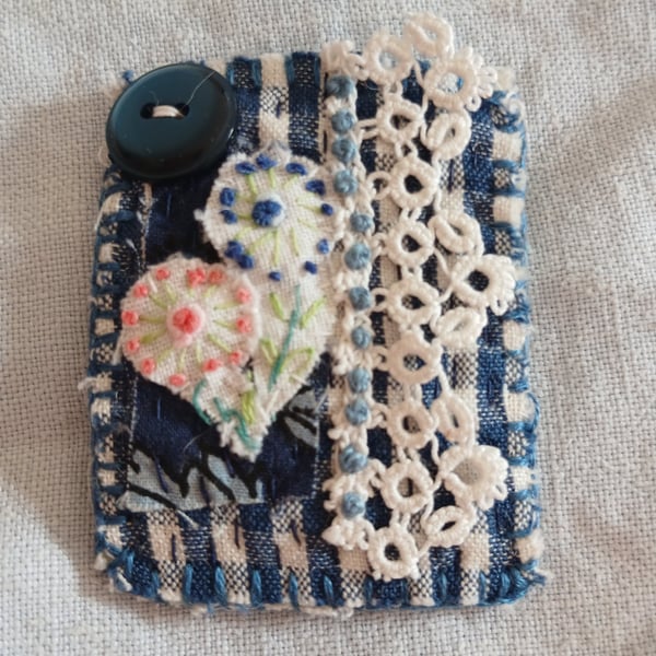 Mini blue and white textile brooch 