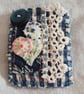 Mini blue and white textile brooch 
