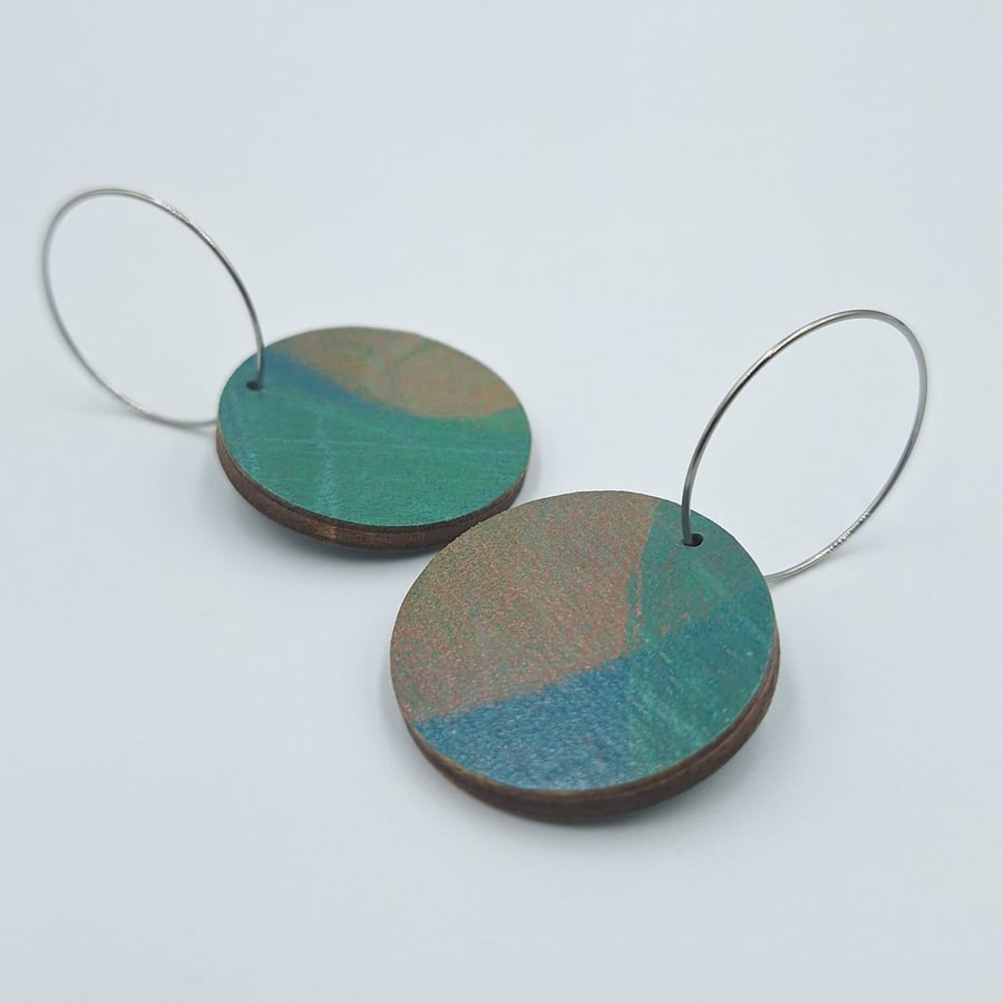 Round, wooden, hand printed hoop earrings in brown pink and blue-green