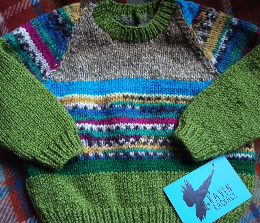 Green patterned hand knitted baby jumper 
