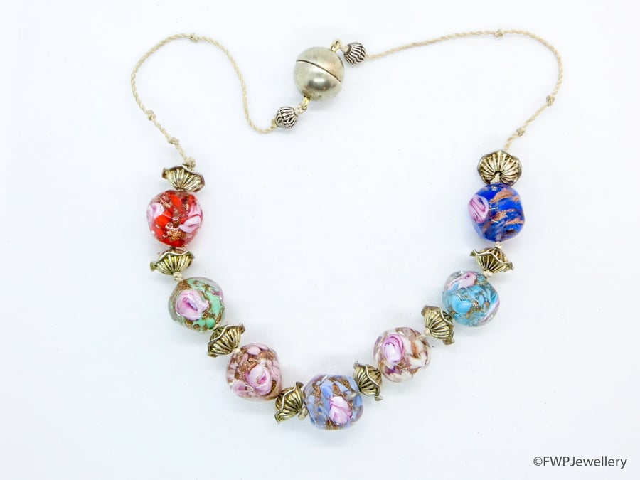 Glass Bead Necklace with Silver Frilly Spacers on White Silk