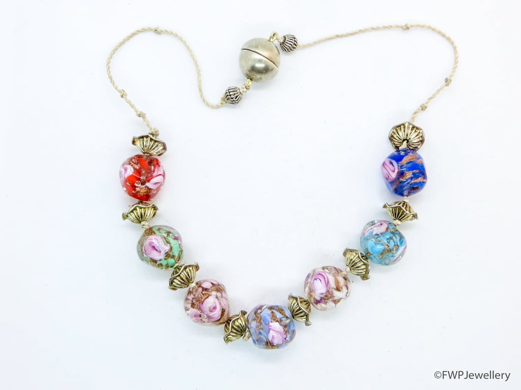 Glass Bead Necklace with Silver Frilly Spacers on White Silk