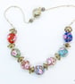 Glass Bead Necklace with Silver Frilly Spacers on White Silk