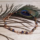 Twisted copper wire bracelet with purple and blue glass beads