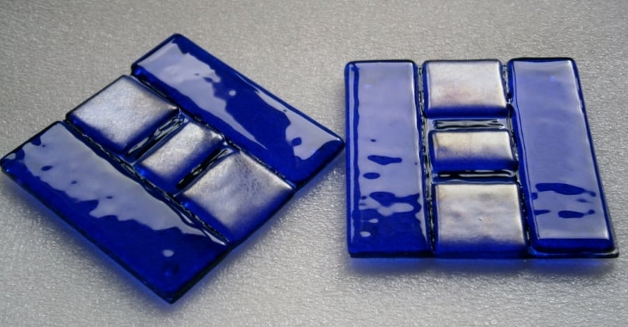 A pair of blue fused glass coasters