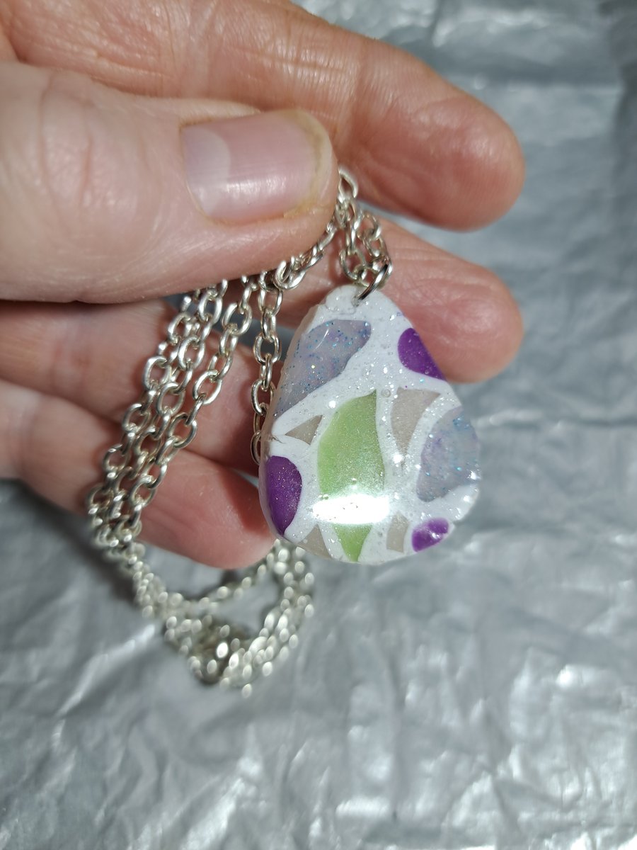 2 designs polymer clay pendant one on a silver plated necklace other rope