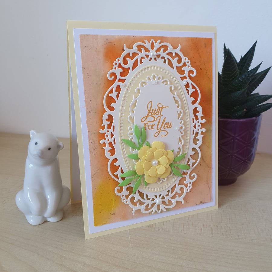An ornate die cut floral birthday card