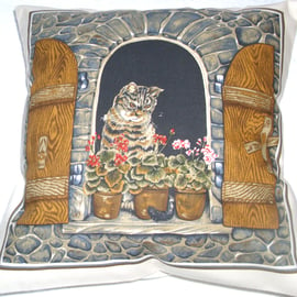 Lovely Grey Tabby cat sitting in window cushion