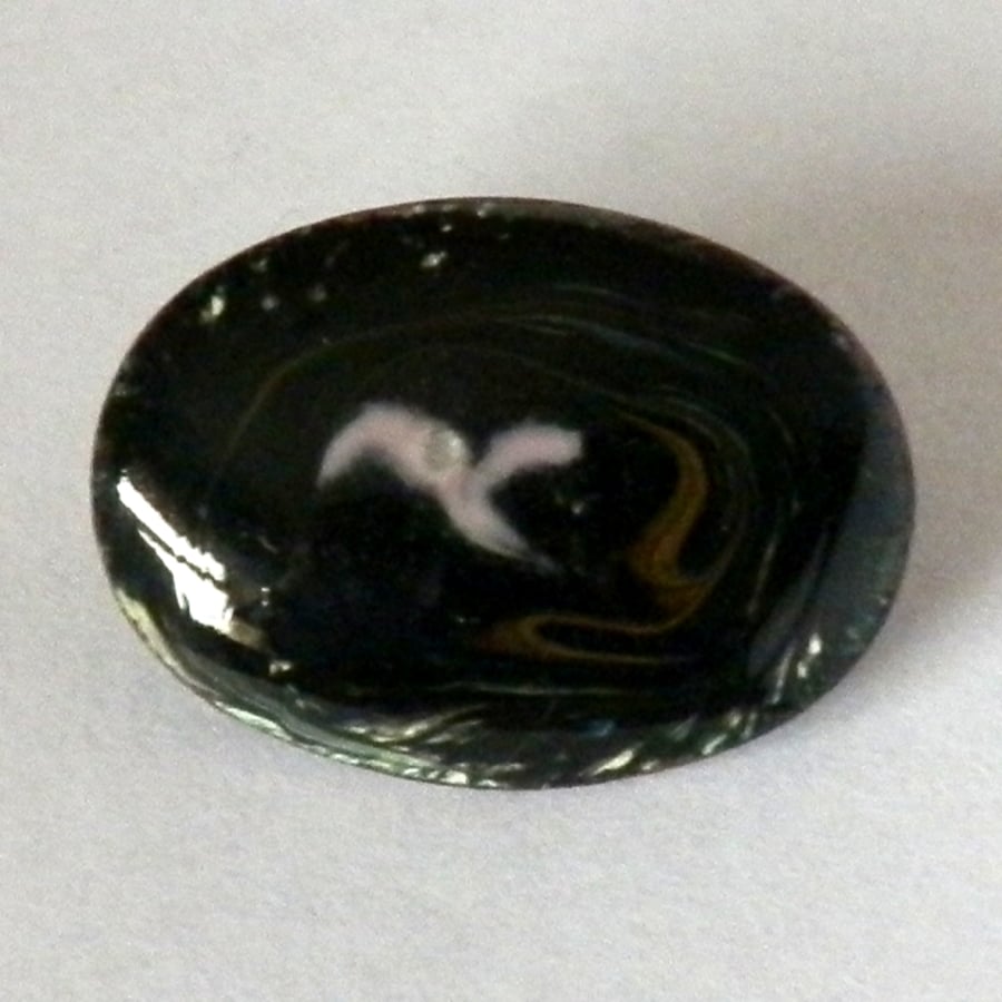 small oval brooch scrolled pink and brown on black