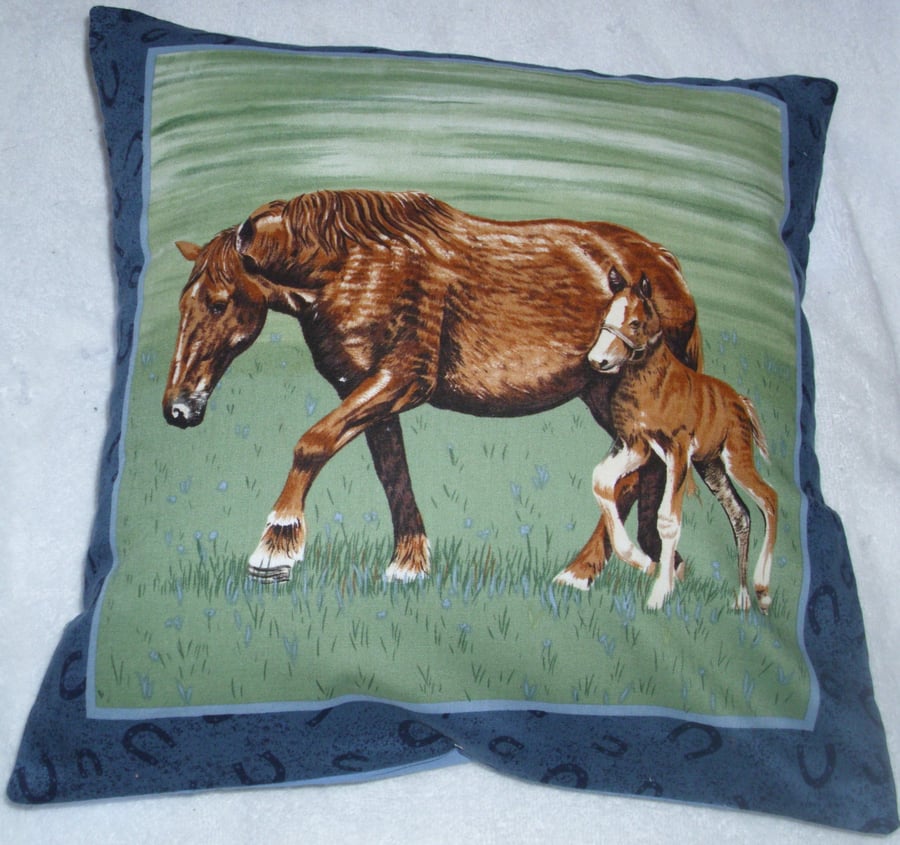 A beautiful brown horse and foal trotting across a field cushion