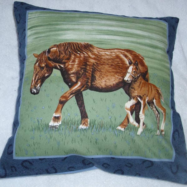 A beautiful brown horse and foal trotting across a field cushion
