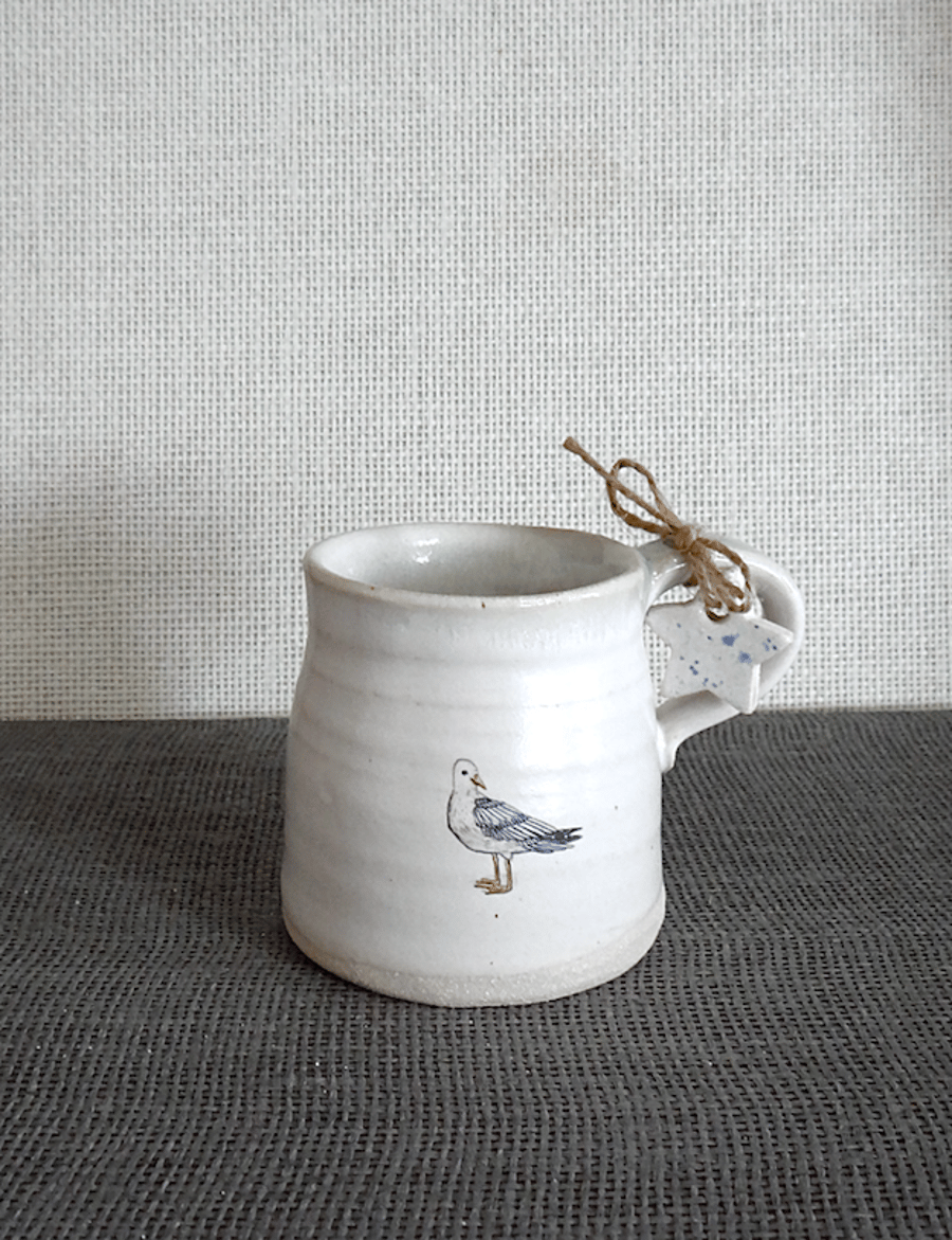 Handmade coast inspired ceramic seagull mug with sea-glass coloured rim