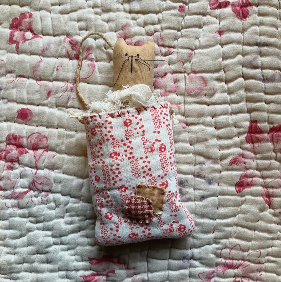 Kitten in vintage quilt pocket