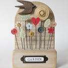 Wildl Flower Garden with Bird in Wood and Clay