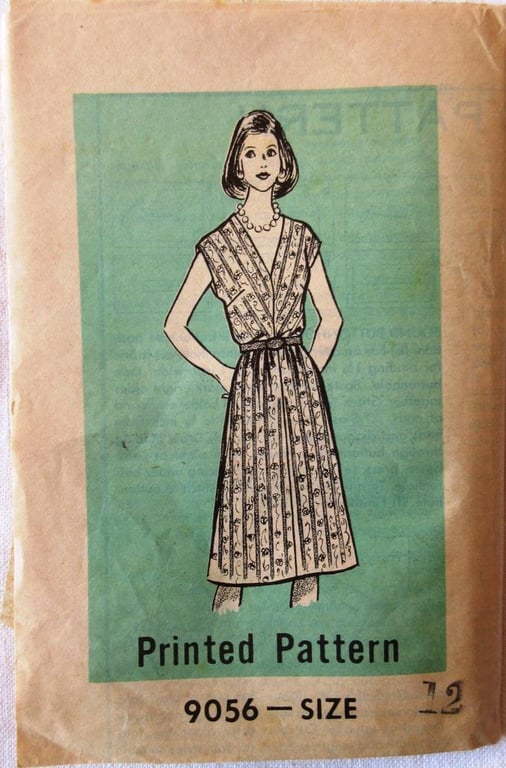 An unused vintage sewing pattern for a woman's cap-sleeved dress in size 12