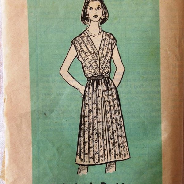 An unused vintage sewing pattern for a woman's cap-sleeved dress in size 12
