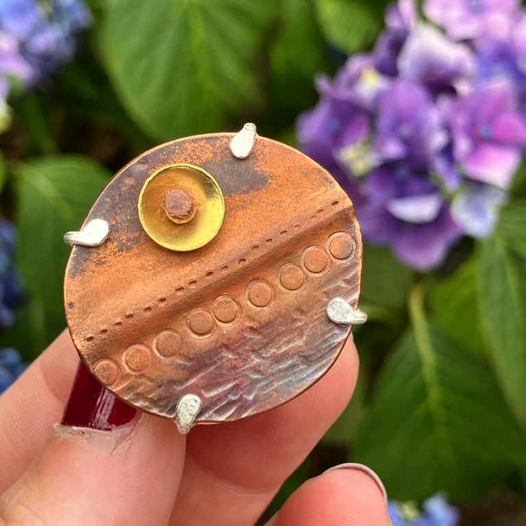 Patinated copper, brass and sterling silver brooch. 