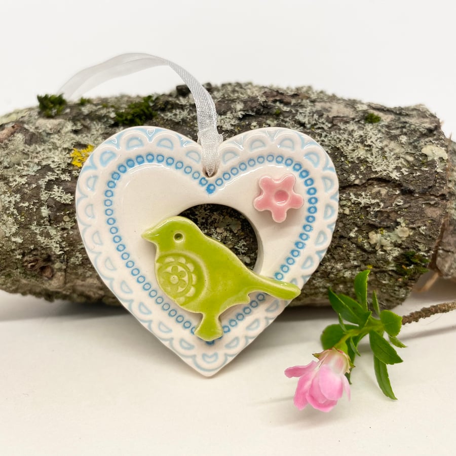 Small Ceramic bird in a blue heart decoration 